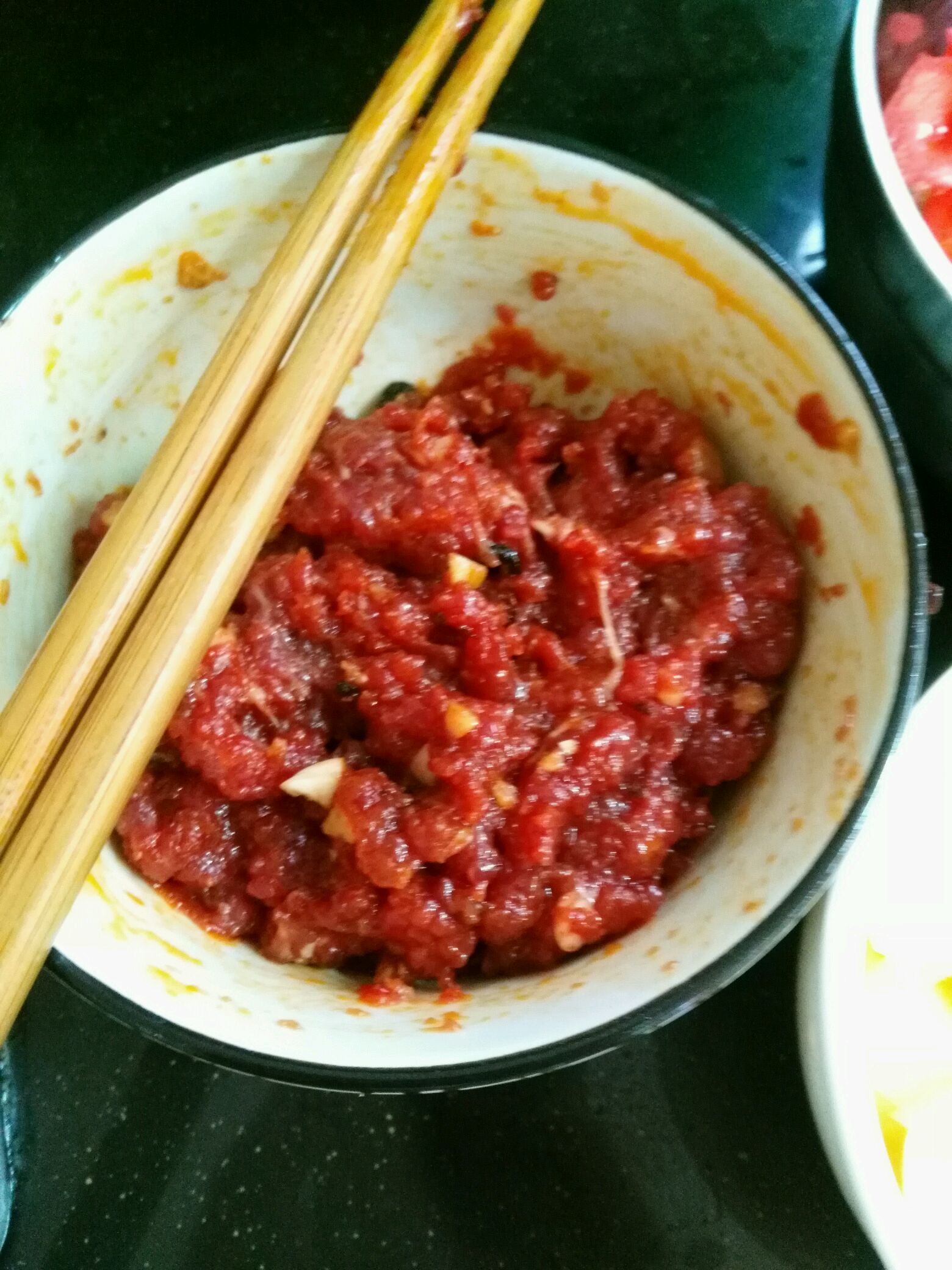 再把牛肉和蒜末一起剁碎,加一点酱油,辣椒酱,生粉搅拌均匀待用