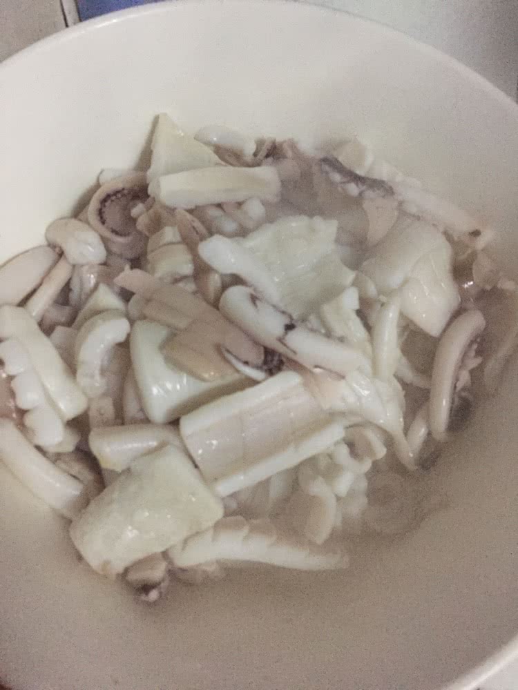 将洗干净的鱿鱼打上花刀然后切片备用